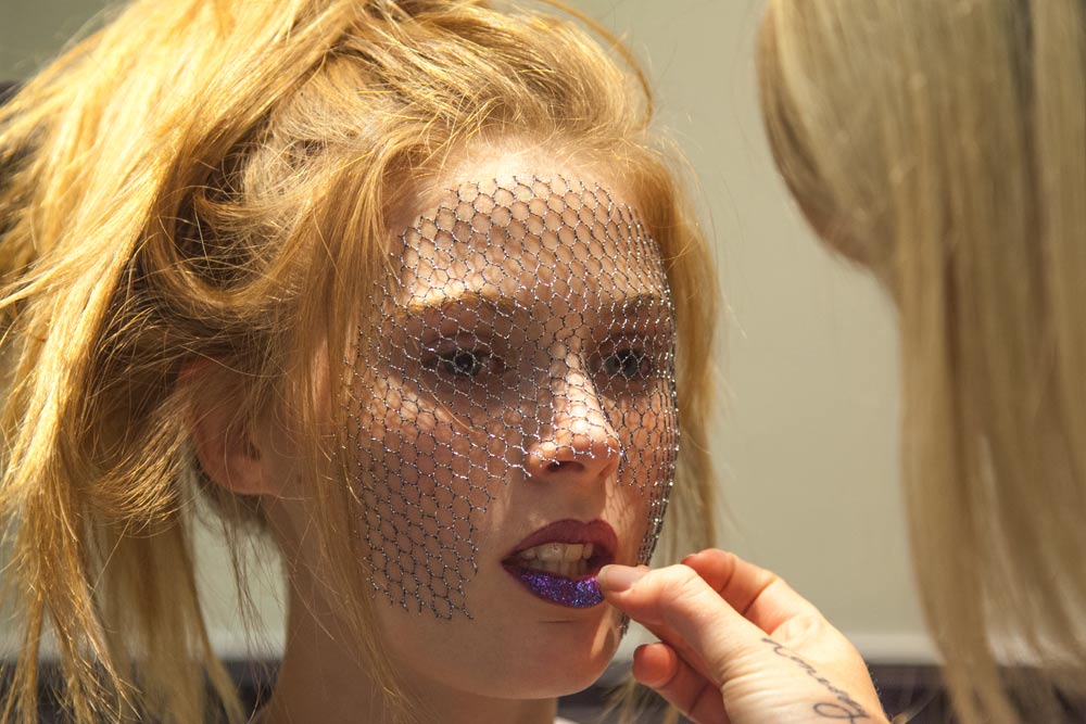 Dramatic beauty makeup with crystal mesh veil and bold lips backstage at fashion show Johannesburg event