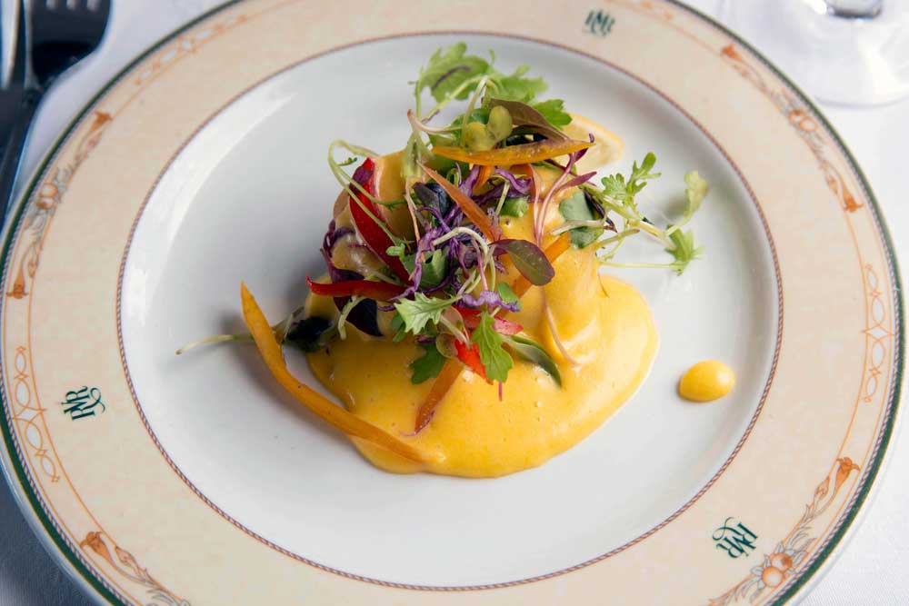 Colourful gourmet salad with vegetables and yellow sauce, professional restaurant food photography